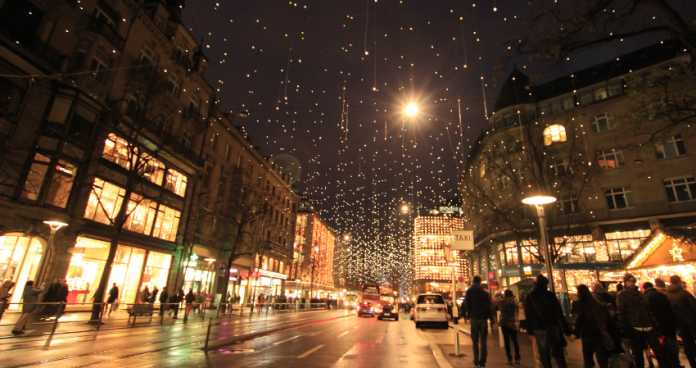 European Christmas market with festive lights and decorated stalls.