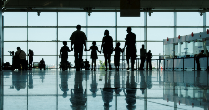 Family with luggage at the airport preparing for their journey to Canada.