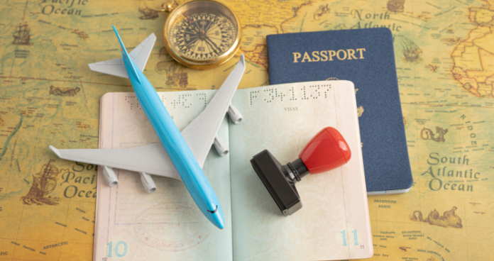 Organized visa application documents and Nigerian passport on a desk, representing readiness for the UK Visitor Visa application.